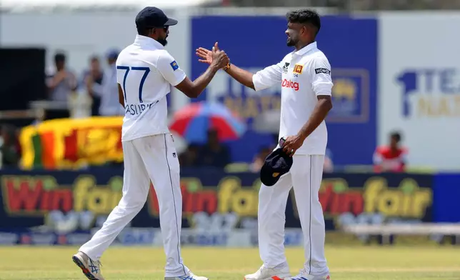 Sri Lanka's Ramesh Mendis, right, and teammate Prabath Jayasuriya celebrate the wicket of New Zealand's William O'Rourke on the third day of the first cricket test match between New Zealand and Sri Lanka in Galle, Sri Lanka, Friday, Sept. 20, 2024. (AP Photo/Viraj Kothalawala)