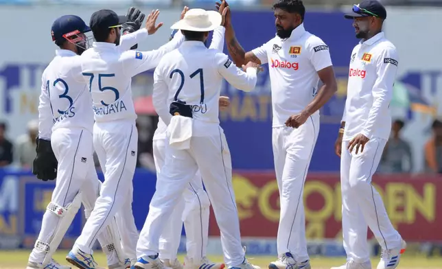 Sri Lanka's Prabath Jayasuriya, second right, celebrates with teammates the wicket of New Zealand's captain Tim Southee on the third day of the first cricket test match between New Zealand and Sri Lanka in Galle, Sri Lanka, Friday, Sept. 20, 2024. (AP Photo/Viraj Kothalawala)