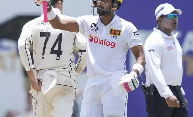 Sri Lanka's Dinesh Chandimal celebrates his fifty runs during the day one of the first test cricket match between Sri Lanka and New Zealand in Galle, Sri Lanka, Thursday, Sept. 26, 2024. (AP Photo/Eranga Jayawardena)