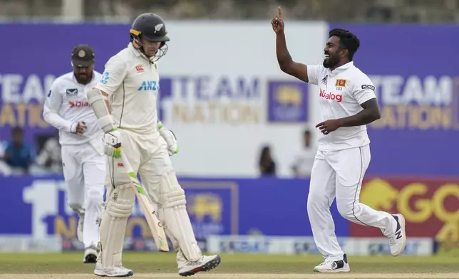 Sri Lanka's Asitha Fernando celebrates the wicket of New Zealand's Tom Latham during the day two of the first test cricket match between Sri Lanka and New Zealand in Galle, Sri Lanka, Friday, Sept. 27, 2024. (AP Photo/Eranga Jayawardena)