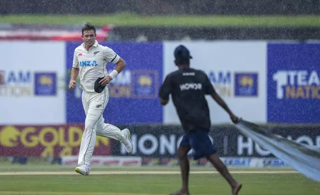 New Zealand's captain Tim Southee runs off the field as it rains during the day one of the first test cricket match between Sri Lanka and New Zealand in Galle , Sri Lanka, Thursday, Sept. 26, 2024. (AP Photo/Eranga Jayawardena)