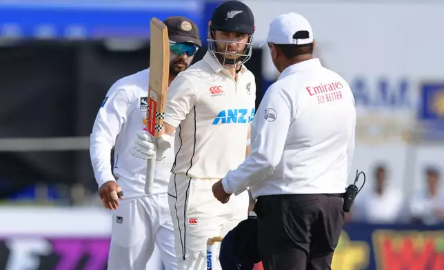 New Zealand's Kane Williamson, center, celebrates his fifty runs on the second day of the first cricket test match between New Zealand and Sri Lanka in Galle, Sri Lanka, Thursday, Sept. 19, 2024. (AP Photo/Viraj Kothalawala)