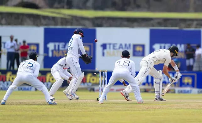 New Zealand's William O'Rourke, right, is bowled out by Sri Lanka's Prabath Jayasuriya resulting in Sri Lanka's win in the first cricket test match against New Zealand in Galle, Sri Lanka, Monday, Sept. 23, 2024. (AP Photo/Viraj Kothalawala)