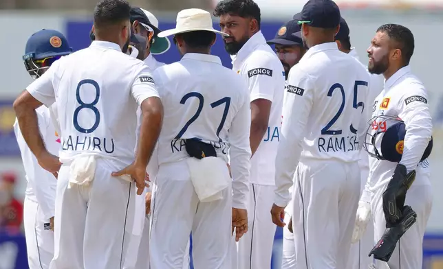 Sri Lanka's Prabath Jayasuriya, center, is surrounded by teammates as he celebrates the wicket of New Zealand's Tom Blundell on the third day of the first cricket test match between New Zealand and Sri Lanka in Galle, Sri Lanka, Friday, Sept. 20, 2024. (AP Photo/Viraj Kothalawala)