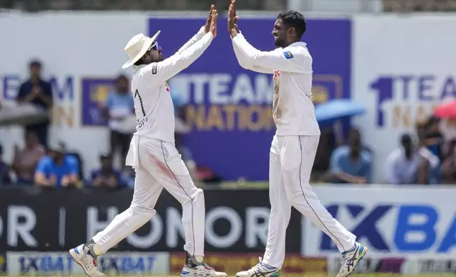 Sri Lanka's Nishan Peiris, right, celebrates the wicket of New Zealand's Glenn Phillips during the day four of the second test cricket match between Sri Lanka and New Zealand in Galle, Sri Lanka, Sunday, Sept. 29, 2024. (AP Photo/Eranga Jayawardena)