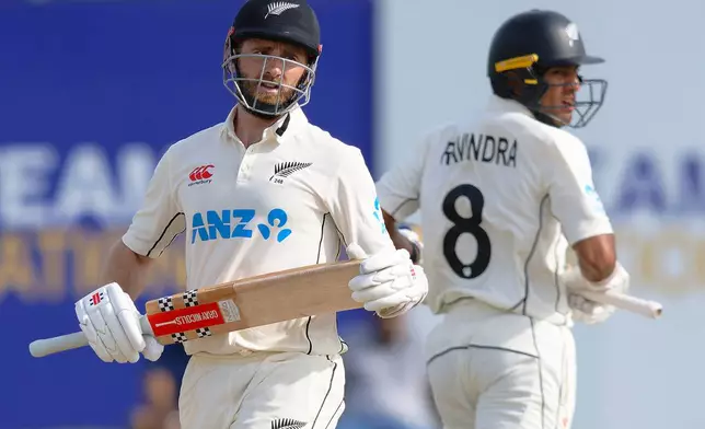 New Zealand's Kane Williamson, left, and teammate Rachin Ravindra run between the wickets on the second day of the first cricket test match between New Zealand and Sri Lanka in Galle, Sri Lanka, Thursday, Sept. 19, 2024. (AP Photo/Viraj Kothalawala)