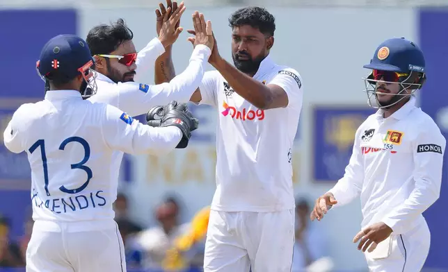 Sri Lanka's Prabath Jayasuriya, second right, celebrates with teammates the wicket of New Zealand's Mitchell Santner on the third day of the first cricket test match between New Zealand and Sri Lanka in Galle, Sri Lanka, Friday, Sept. 20, 2024. (AP Photo/Viraj Kothalawala)