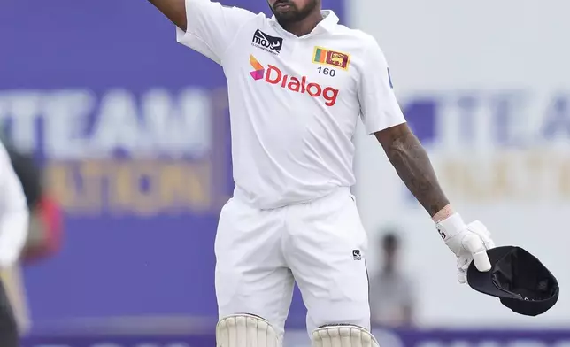 Sri Lanka's Kamindu Mendis celebrates his century during the day two of the first test cricket match between Sri Lanka and New Zealand in Galle, Sri Lanka, Friday, Sept. 27, 2024. (AP Photo/Eranga Jayawardena)