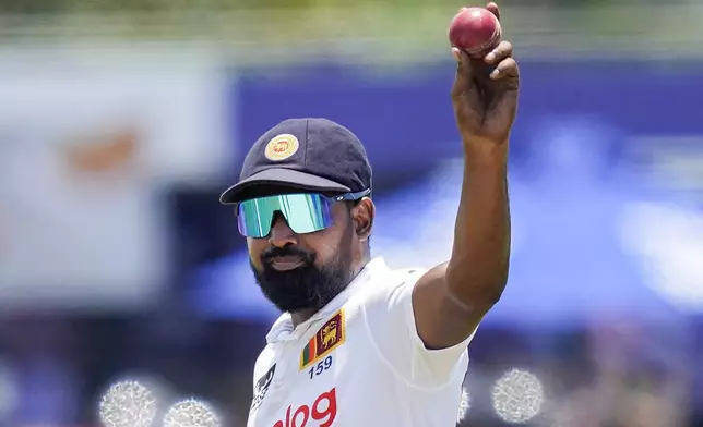 Sri Lanka's Prabath Jayasuriya acknowledges after taking six New Zealand wickets during the day three of the second test cricket match between Sri Lanka and New Zealand in Galle , Sri Lanka, Saturday, Sept. 28, 2024. (AP Photo/Eranga Jayawardena)