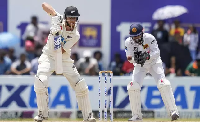 New Zealand's Mitchell Santner plays a shot during the day four of the second test cricket match between Sri Lanka and New Zealand in Galle, Sri Lanka, Sunday, Sept. 29, 2024. (AP Photo/Eranga Jayawardena)