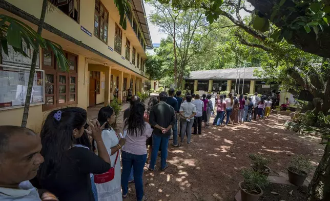 People wait in a queue to cast their votes at a polling center during the presidential election on the outskirts of Colombo , Sri Lanka Saturday, Sept. 21, 2024.(AP Photo/Rajesh Kumar Singh)