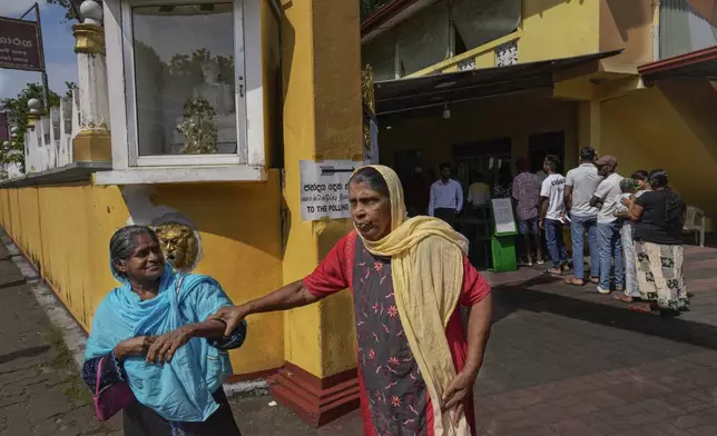 Elderly women leave a polling station after casting their votes during the presidential election in Colombo, Sri Lanka, Saturday, Sept. 21, 2024. (AP Photo/Eranga Jayawardena)