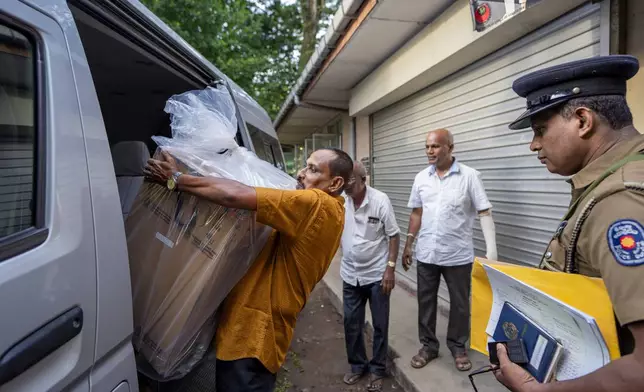 Polling officials carry a sealed ballot box as they return it to a counting center at the end of voting during presidential election in Colombo, Sri Lanka, Saturday, Sept. 21, 2024. (AP Photo/Rajesh Kumar Singh)