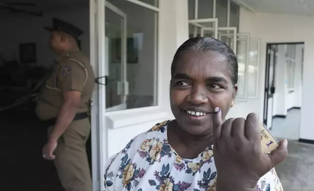 An Sri Lanka woman displays the indelible ink mark on her finger after casting her vote outside a polling station during presidential election in Colombo, Sri Lanka, Saturday, Sept. 21, 2024. (AP Photo/Rajesh Kumar Singh)