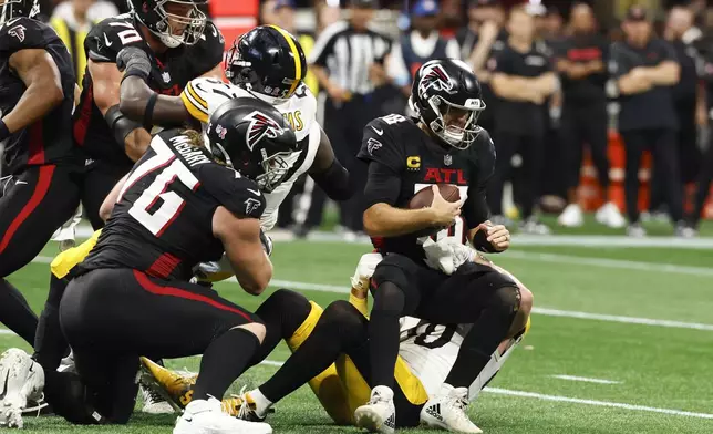 Pittsburgh Steelers linebacker T.J. Watt (90) sacks Atlanta Falcons quarterback Kirk Cousins (18) during the second half of an NFL football game Sunday, Sept. 8, 2024, in Atlanta. (AP Photo/Butch Dill)