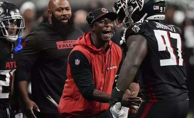 Atlanta Falcons head coach Raheem Morris congratulates Atlanta Falcons defensive end Grady Jarrett (97) after a sack during the second half of an NFL football game against the Pittsburgh Steelers on Sunday, Sept. 8, 2024, in Atlanta. (AP Photo/John Bazemore)