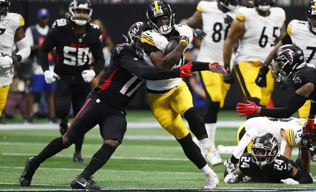 Pittsburgh Steelers running back Najee Harris (22) is stopped by Atlanta Falcons linebacker Arnold Ebiketie (17) during the second half of an NFL football game Sunday, Sept. 8, 2024, in Atlanta. (AP Photo/Butch Dill)