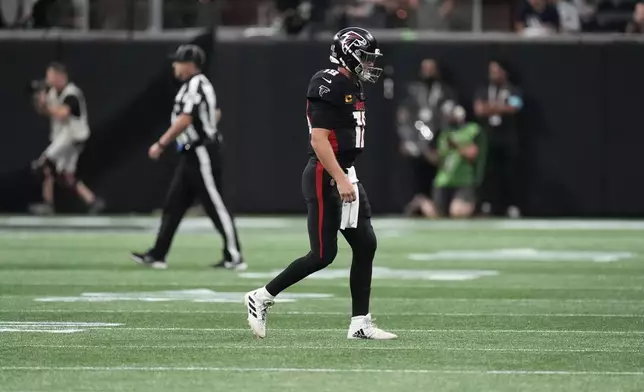 Atlanta Falcons quarterback Kirk Cousins walks off the field after an interception during the second half of an NFL football game against the Pittsburgh Steelers on Sunday, Sept. 8, 2024, in Atlanta. (AP Photo/John Bazemore)