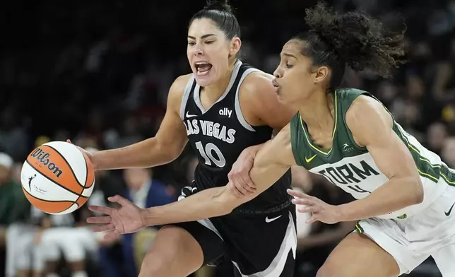 Las Vegas Aces guard Kelsey Plum (10) drives against Seattle Storm guard Skylar Diggins-Smith (4) during the second half in Game 2 of a WNBA basketball first-round playoff game Tuesday, Sept. 24, 2024, in Las Vegas. (AP Photo/John Locher)