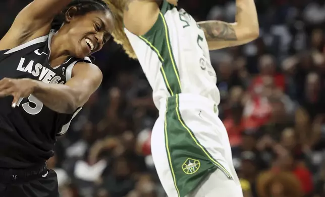 Las Vegas Aces guard Tiffany Hayes (15) jumps to block Seattle Storm forward Gabby Williams (5) during a first-round WNBA basketball playoff game Sunday, Sept. 22, 2024, in Las Vegas. (AP Photo/Ronda Churchill)