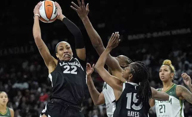 Las Vegas Aces center A'ja Wilson (22) grabs a rebound against the Seattle Storm during the second half in Game 2 of a WNBA basketball first-round playoff game Tuesday, Sept. 24, 2024, in Las Vegas. (AP Photo/John Locher)