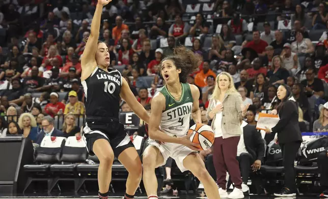 Seattle Storm guard Skylar Diggins-Smith (4) guards the ball from Las Vegas Aces guard Kelsey Plum (10) during a first-round WNBA basketball playoff game, Sunday, Sept. 22, 2024, in Las Vegas. (AP Photo/Ronda Churchill)