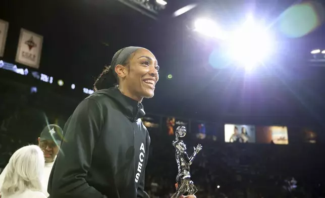 Las Vegas Aces center A'ja Wilson (22) receives the 2024 WMBA MVP award prior to playing in a first-round WNBA basketball playoff game against the Seattle Storm Sunday, Sept. 22, 2024, in Las Vegas. (AP Photo/Ronda Churchill)