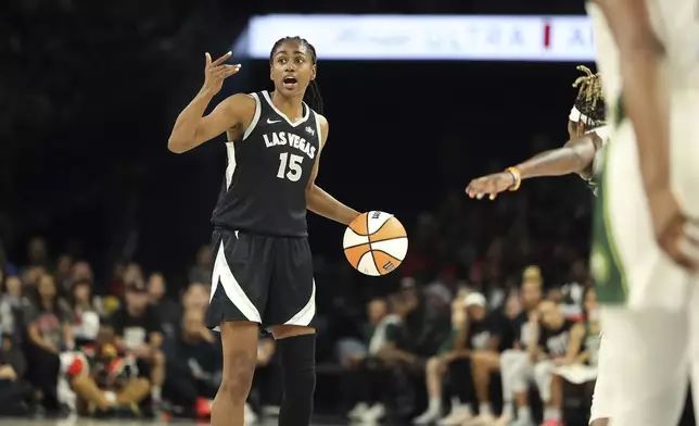 Las Vegas Aces guard Tiffany Hayes (15) signals during a first-round WNBA basketball playoff game against the Seattle Storm, Sunday, Sept. 22, 2024, in Las Vegas. (AP Photo/Ronda Churchill)