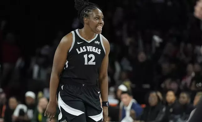 Las Vegas Aces guard Chelsea Gray (12) celebrates after making a 3-point shot against the Seattle Storm during the second half in Game 2 of a WNBA basketball first-round playoff game Tuesday, Sept. 24, 2024, in Las Vegas. (AP Photo/John Locher)