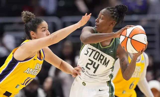 Seattle Storm guard Jewell Loyd, right, tries to pass as Los Angeles Sparks guard Kia Nurse defends during the second half of a WNBA basketball game, Wednesday, Sept. 11, 2024, in Los Angeles. (AP Photo/Mark J. Terrill)