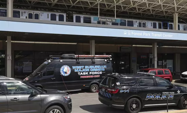 Police vehicles are parked outside the CTA Forest Park station, Monday, Sept. 2, 2024, in Forest Park, Ill. (John J. Kim/Chicago Tribune via AP)