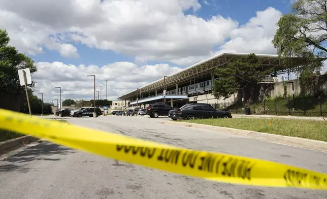 Yellow tape blocks off the parking lot of the Forest Park Blue Line train station in Forest Park, Ill., after four people were fatally shot on the train early Monday, Sept. 2, 2024. (Pat Nabong/Chicago Sun-Times via AP)