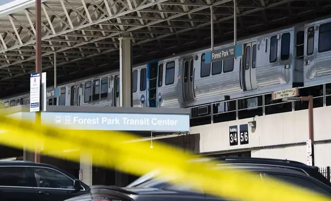 Yellow tape blocks off the parking lot of the Forest Park Blue Line train station in Forest Park, Ill., after four people were fatally shot on the train early Monday, Sept. 2, 2024. (Pat Nabong/Chicago Sun-Times via AP)