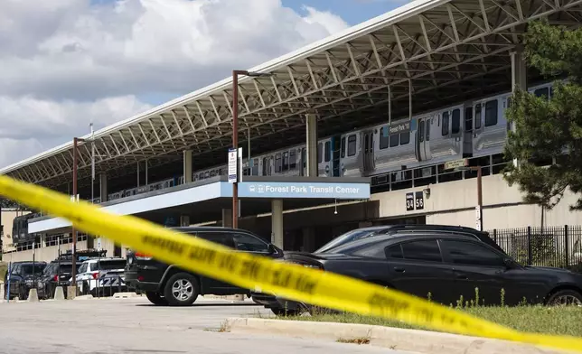 Yellow tape blocks off the parking lot of the Forest Park Blue Line train station in Forest Park, Ill., after four people were fatally shot on the train early Monday, Sept. 2, 2024. (Pat Nabong/Chicago Sun-Times via AP)