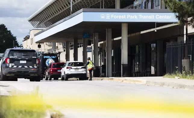 Yellow tape blocks off the parking lot of the Forest Park Blue Line train station in Forest Park, Ill., after four people were fatally shot on the train early Monday, Sept. 2, 2024. (Pat Nabong/Chicago Sun-Times via AP)