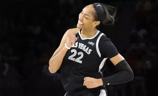 Las Vegas Aces center A'ja Wilson (22) celebrates after making a basket during the first half of a WNBA basketball game against the Connecticut Sun, Sunday, Sept. 15, 2024, in Las Vegas. (Steve Marcus/Las Vegas Sun via AP)