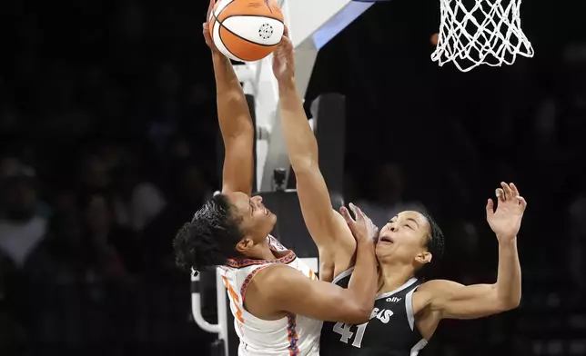 Connecticut Sun forward Alyssa Thomas (25) shoots against Las Vegas Aces center Kiah Stokes (41) during the first half of a WNBA basketball game Sunday, Sept. 15, 2024, in Las Vegas. (Steve Marcus/Las Vegas Sun via AP)