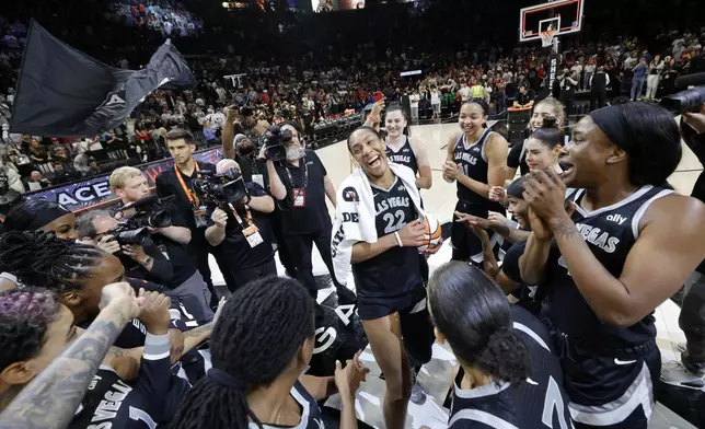 Las Vegas Aces center A'ja Wilson, center, celebrates with teammates after an WNBA basketball game against the Connecticut Sun Sunday, Sept. 15, 2024, in Las Vegas. (Steve Marcus/Las Vegas Sun via AP)