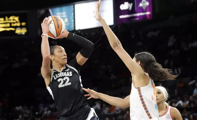 Las Vegas Aces center A'ja Wilson (22) shoots over Connecticut Sun forward Olivia Nelson-Ododa (10) during the first half of a WNBA basketball game Sunday, Sept. 15, 2024, in Las Vegas. (Steve Marcus/Las Vegas Sun via AP)