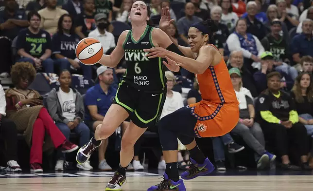 Minnesota Lynx forward Bridget Carleton (6) is fouled by Connecticut Sun forward Brionna Jones, right, during the first half of Game 1 of a WNBA basketball semifinals series Sunday, Sept. 29, 2024, in Minneapolis. (AP Photo/Stacy Bengs)