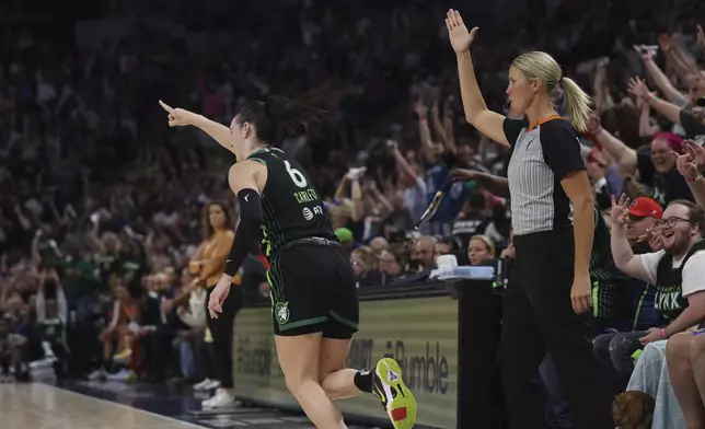 Minnesota Lynx forward Bridget Carleton (6) reacts after scoring a 3-point basket during the first half of Game 1 of a WNBA basketball semifinals against the Connecticut Sun, series Sunday, Sept. 29, 2024, in Minneapolis. (AP Photo/Stacy Bengs)