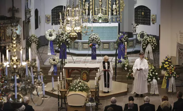 People attend the funeral service of Swedish soccer manager Sven-Goran Eriksson at Fryksände church in Torsby, Sweden, Friday Sept. 13, 2024. (Adam Ihse/TT News Agency via AP)