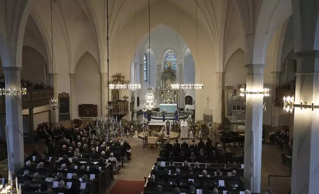 People attend the funeral service of Swedish soccer manager Sven-Goran Eriksson at Fryksände church in Torsby, Sweden, Friday Sept. 13, 2024. (Adam Ihse/TT News Agency via AP)