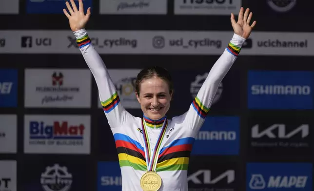 Grace Brown of Australia celebrates on the podium after the women elite individual time trial over 29.9 kilometres (18.6 miles) at the Cycling World Championships in Zurich, Switzerland, Sunday, Sept. 22, 2024. (AP Photo/Peter Dejong)