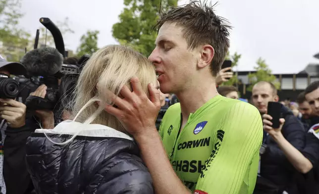 Slovenia's Tadej Pogacar kisses his girlfriend Urska Zigar after winning the Men Elite road race of the Cycling and Para-cycling Road World Championships in Zurich, Switzerland, Sunday, Sept. 29, 2024. (Michael Buholzer/Keystone via AP)