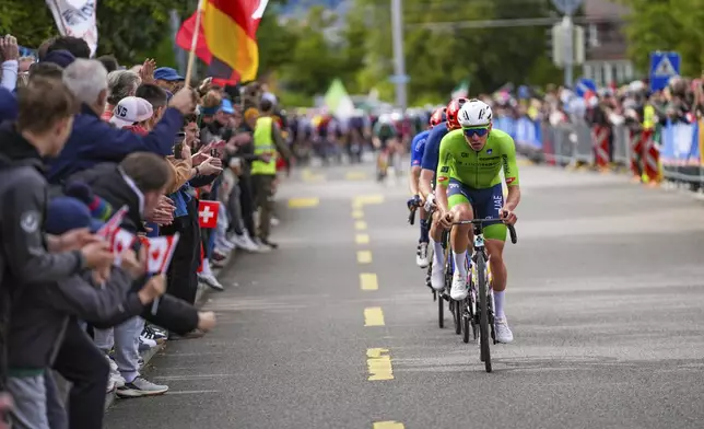 Slovenia's Tadej Pogacar attacks during the Men Elite road race of the Cycling and Para-cycling Road World Championships in Zurich, Switzerland, Sunday, Sept. 29, 2024. (Zac Williams/SWpix.com/Pool Photo via AP)