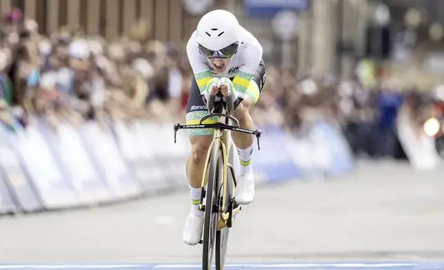 Grace Brown of Australia crosses the finish line to win the women elite individual time trial over 29.9 kilometers (18.6 miles) at the Cycling World Championships in Zurich, Switzerland, Sunday, Sept. 22, 2024. (Michael Buholzer/Keystone via AP)