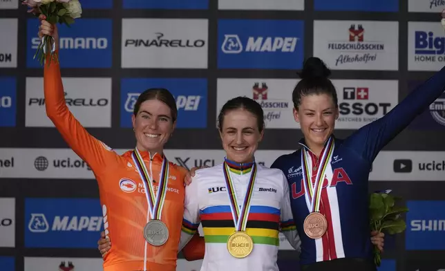 New World Champion Grace Brown of Australia, center, Demi Vollering of the Netherlands, left and silver medal, and Chloe Dygert of the U.S., right and bronze medal, celebrate on the podium after the women elite individual time trial over 29.9 kilometres (18.6 miles) at the Cycling World Championships in Zurich, Switzerland, Sunday, Sept. 22, 2024. (AP Photo/Peter Dejong)