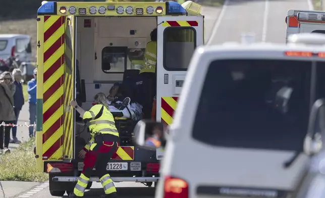 Julian Alaphilippe of France is loaded into the ambulance after a crash during the Men Elite Road Race at the 2024 UCI Road and Para-cycling Road World Championships in Effretikon, Switzerland Sunday, Sept. 29, 2024. (Til Buergy/Keystone via AP)