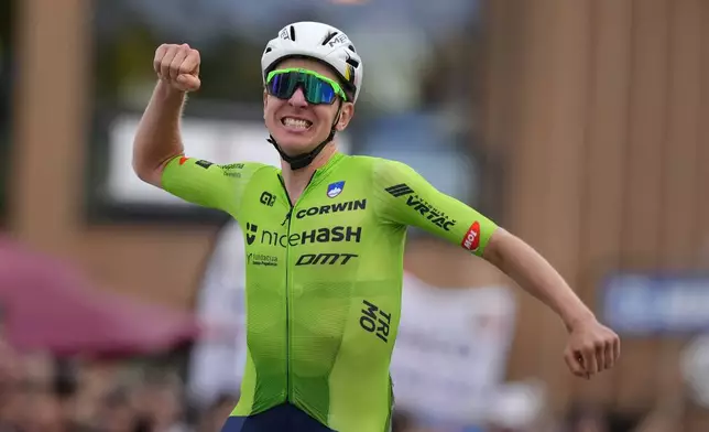 Slovenia's Tadej Pogacar crosses the finish line to win the Men Elite road race of the Cycling and Para-cycling Road World Championships in Zurich, Switzerland, Sunday, Sept. 29, 2024. (AP Photo/Peter Dejong)